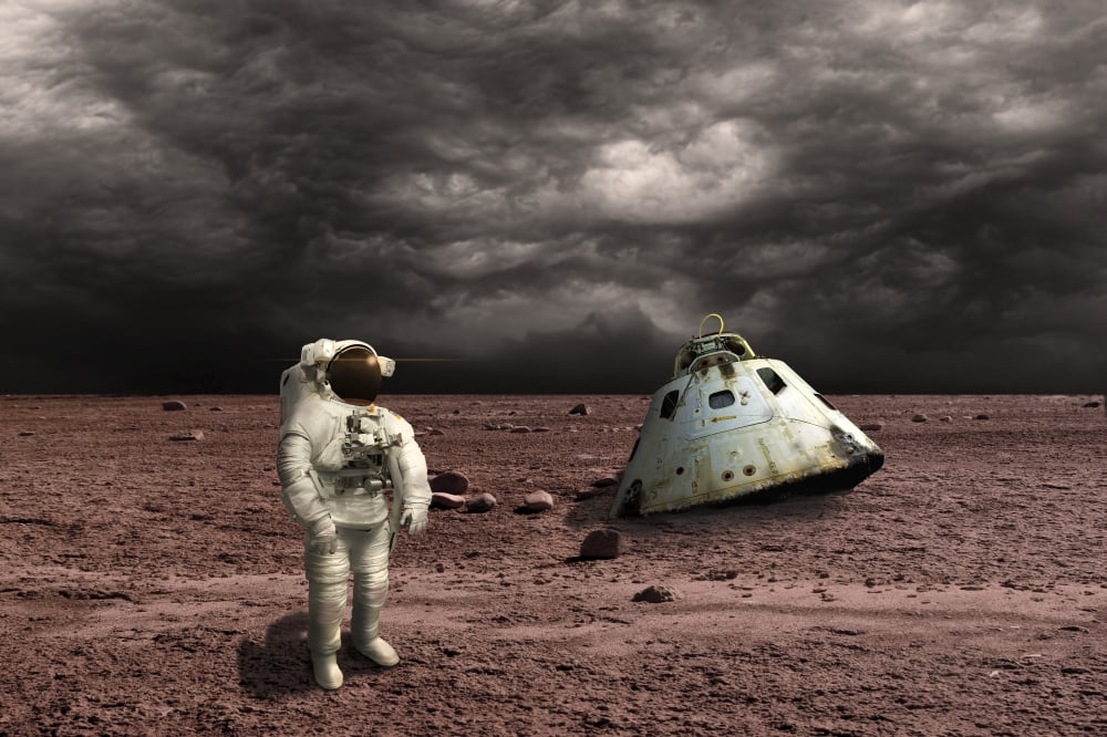 An astronaut surveys his situation after being marooned on a barren planet Canvas Art - Marc WardStocktrek Images (35 x 23)