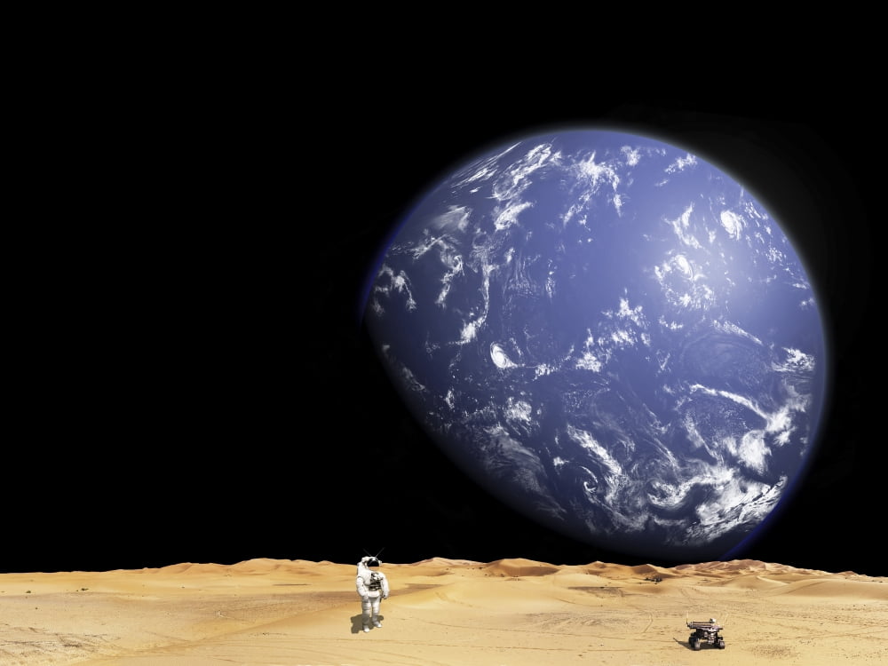 An astronaut works with his rover while exploring a barren moon Canvas Art - Marc WardStocktrek Images (17 x 13)