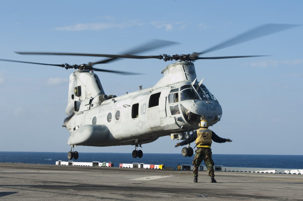 An aviation boatswains mate directs a CH-46E Sea Knight Canvas Art - Stocktrek Images (35 x 23)