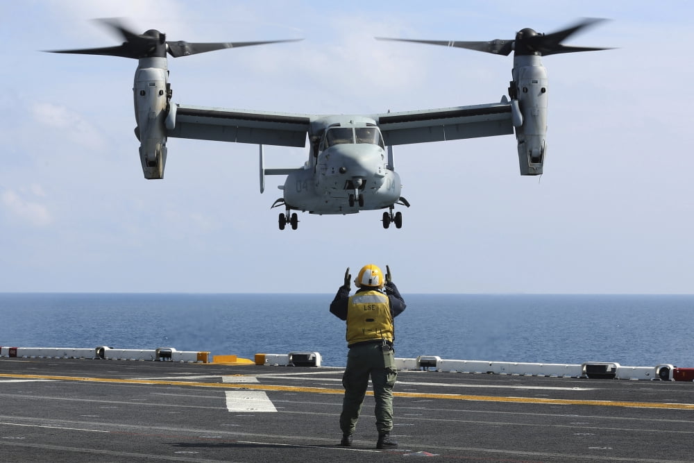 An aviation boatswains mate directs the landing of an MV-22 Osprey Canvas Art - Stocktrek Images (35 x 23)