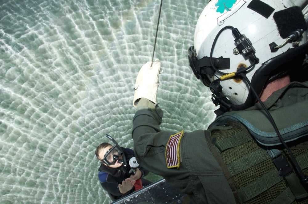An aviation rescue swimmer instructor is hoisted into a SH-60F Sea Hawk Canvas Art - Stocktrek Images (35 x 24)