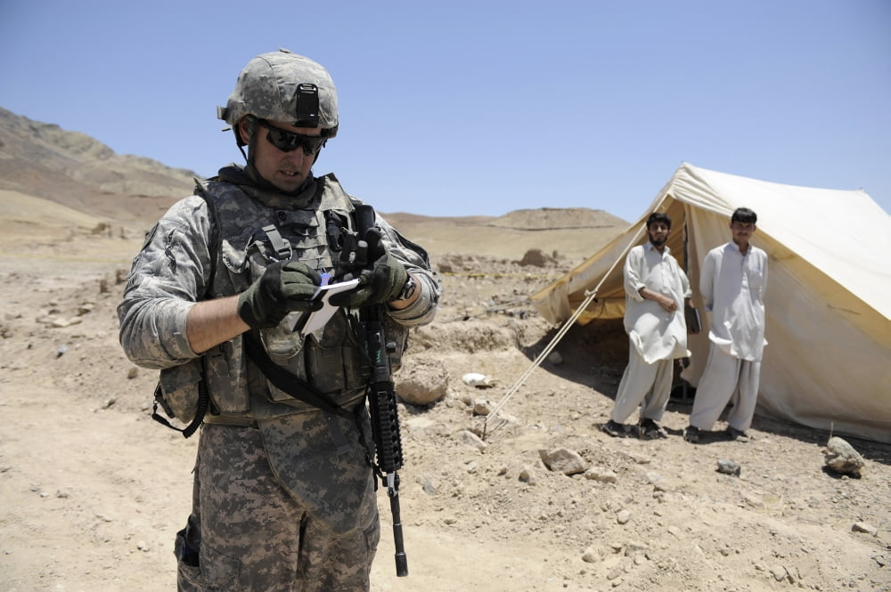 An engineer conducts a quality assurance inspection of a development site in Afghanistan Canvas Art - Stocktrek Images (34 x 23)
