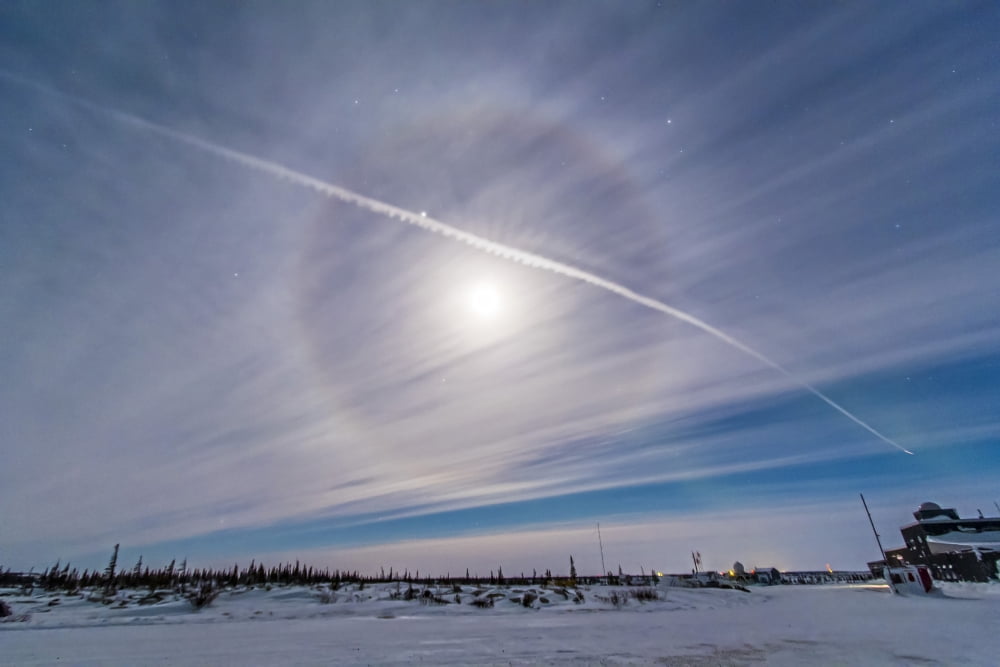 An ice crystal lunar halo around the gibbous moon with an aircraft jet contrail Canvas Art - Alan DyerStocktrek Images (34 x 23)