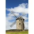 thumbnail image 1 of An old stone windmill on a hillside with wooden blades surrounded by a stone fence with blue sky and clouds; Brehec Br 1, 1 of 3