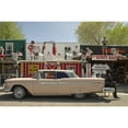 thumbnail image 1 of An old yellow ford sits on the highway in front of the Rusty Bolt retail store. The building is adorned on two levels with manikins in a variety of poses Poster Print (24 x 36), 1 of 3