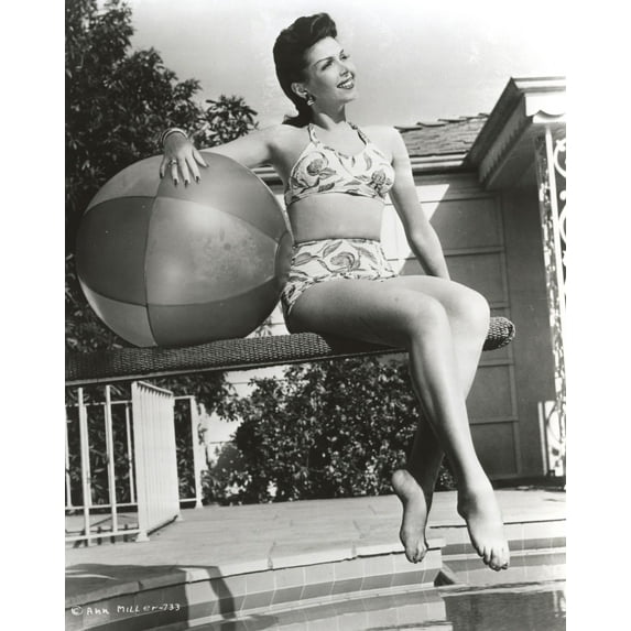Ann Miller sitting on the Jumping Board Holding a Ball in a Classic Portrait Photo Print (8 x 10)