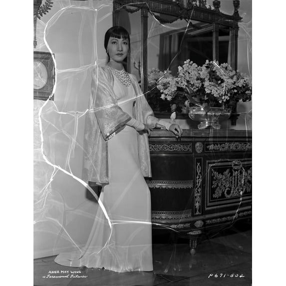 Anna Wong Leaning on a Table, wearing a Long White Dress Photo Print (8 x 10)
