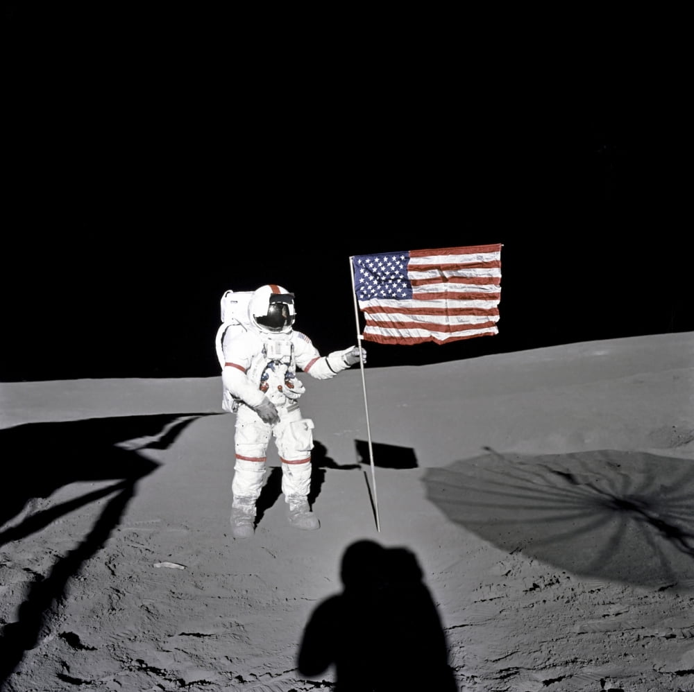Apollo astronaut stands beside the United States flag after it was unfurled on the lunar surface Canvas Art - Stocktrek Images (28 x 28)
