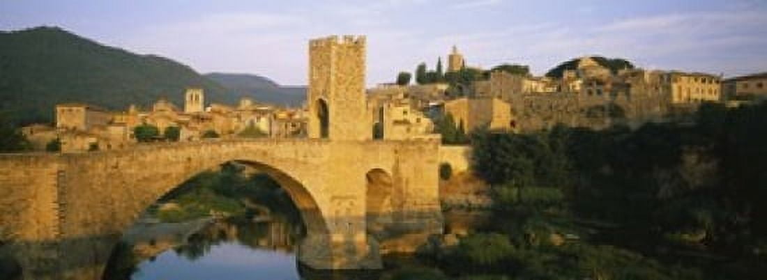 Arch bridge across a river in front of a city Besalu Catalonia Spain Canvas Art - Panoramic Images (18 x 7)