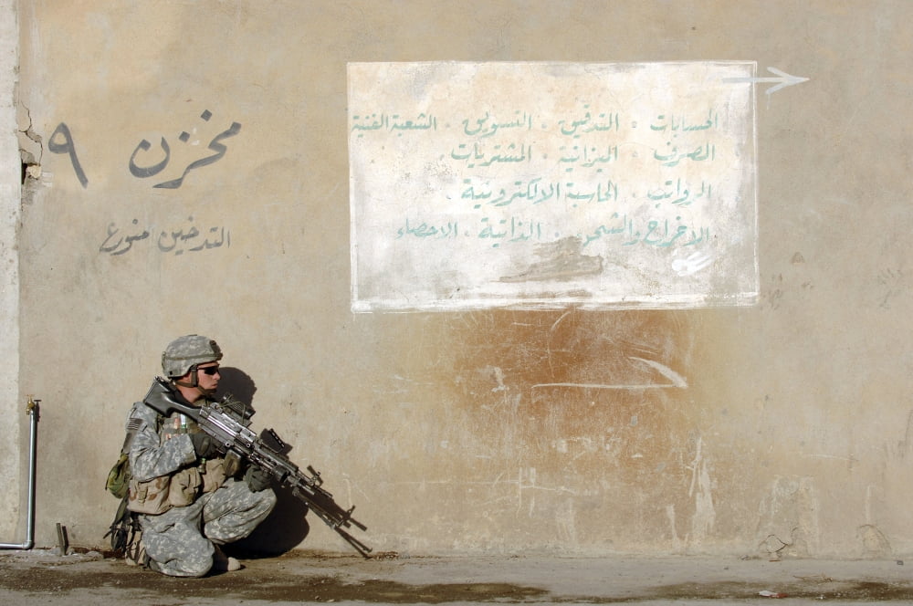 Army Specialist kneeling next to a wall during a search in Mosul Iraq Canvas Art - Stocktrek Images (35 x 23)
