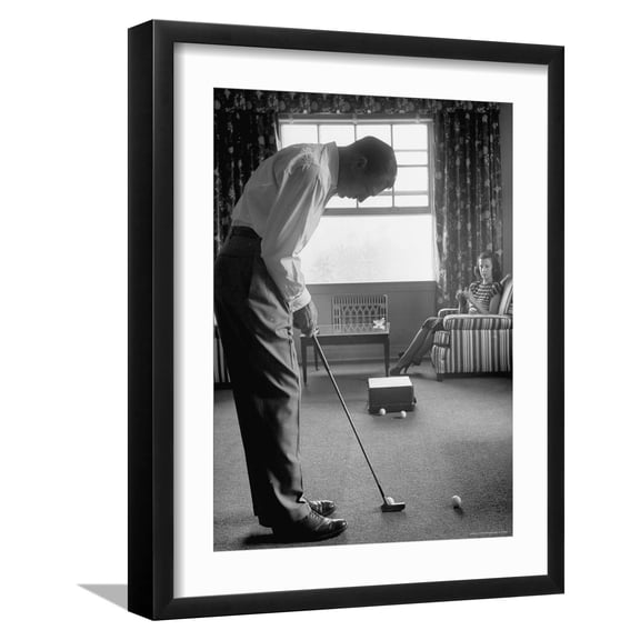 Art.com Golfer Ben Hogan Practicing Putting in His town house with Wife Valerie Watching from Armchair Premium Photographic Print by Loomis Dean, Black Frame Wall Art, 17" x 21"