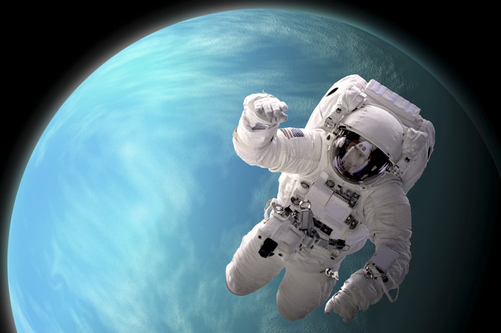Artists concept of an astronaut floating in outer space by a water covered planet Canvas Art - Marc WardStocktrek Images (34 x 23)