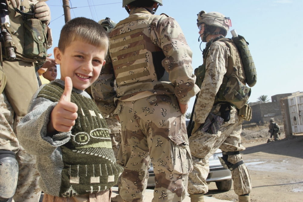 As a father is questioned by Marines Iraqi Army soldiers his son gives the thumbs up Canvas Art - Stocktrek Images (34 x 23)