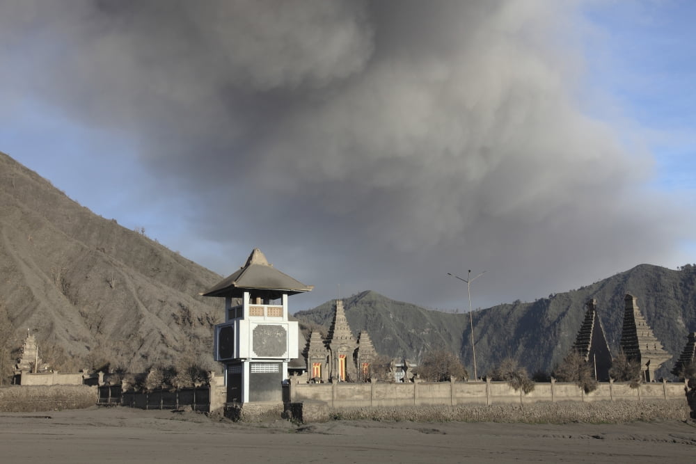 Ash cloud passing over temple at foot of Mount Bromo Volcano Tengger Caldera Java Indonesia Canvas Art - Richard RoscoeStocktrek Images (35 x 23)
