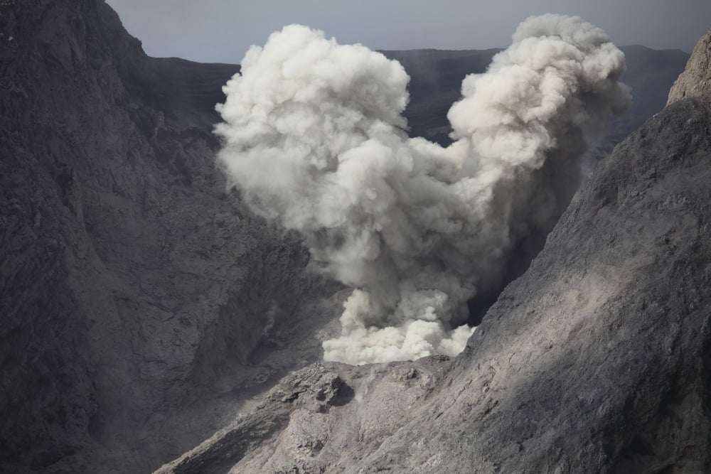 Ash cloud rises from crater of Batu Tara volcano Indonesia Canvas Art - Richard RoscoeStocktrek Images (18 x 12)