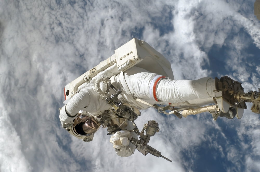 Astronaut anchored to a Canadarm2 mobile foot restraint Canvas Art - Stocktrek Images (34 x 23)