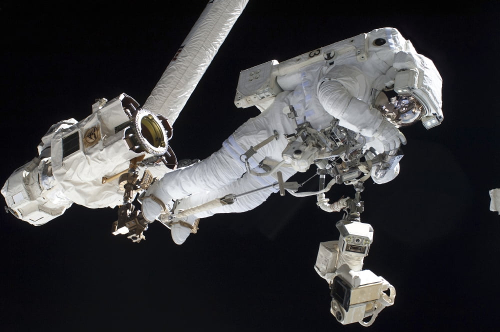 Astronaut anchored to a Canadarm2 mobile foot restraint Canvas Art - Stocktrek Images (34 x 23)