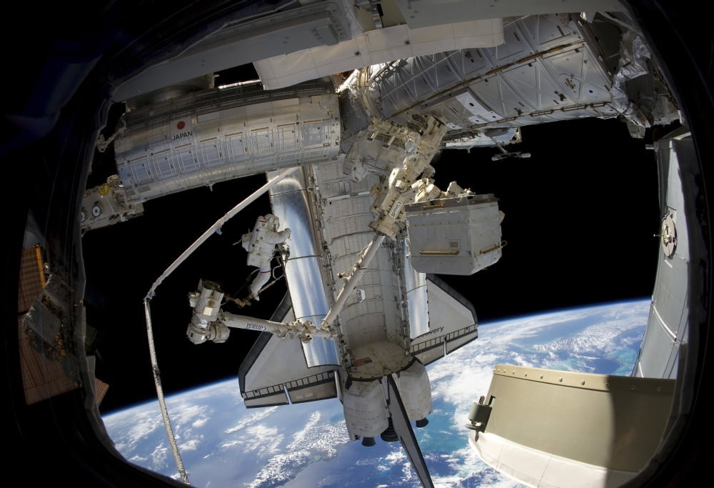 Astronaut anchored to a foot restraint during a spacewalk Canvas Art - Stocktrek Images (34 x 24)