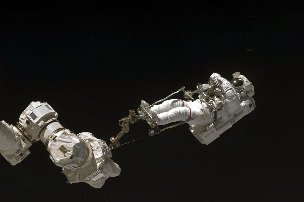 Astronaut attached to a foot restraint during extravehicular activity Canvas Art - Stocktrek Images (34 x 23)