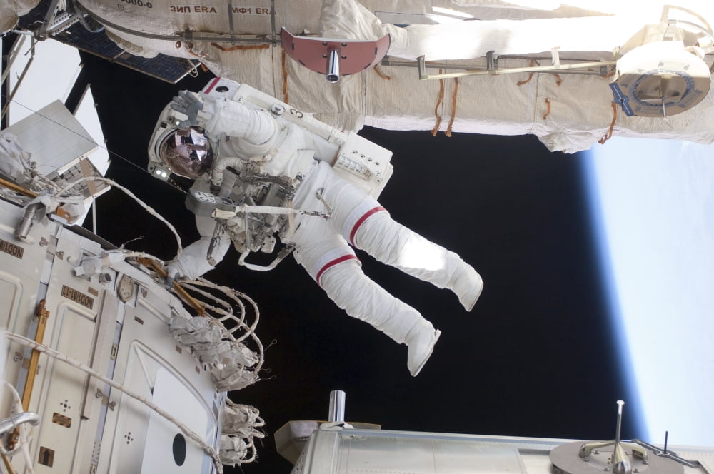 Astronaut conducts a spacewalk on the International Space Station Canvas Art - Stocktrek Images (34 x 23)
