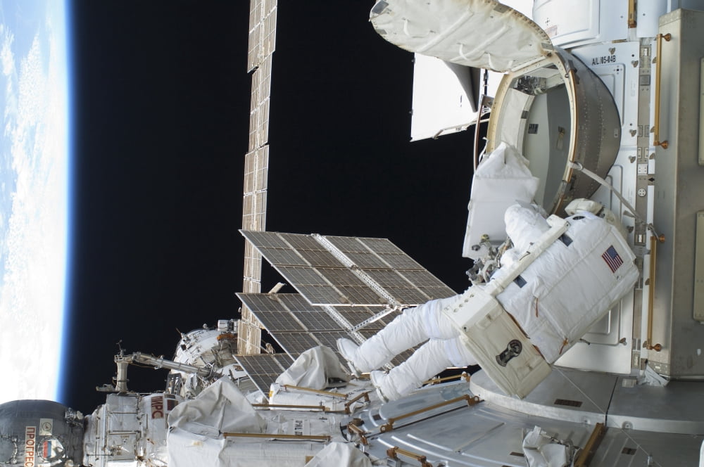 Astronaut egresses the Quest airlock on the International Space Station Canvas Art - Stocktrek Images (34 x 23)