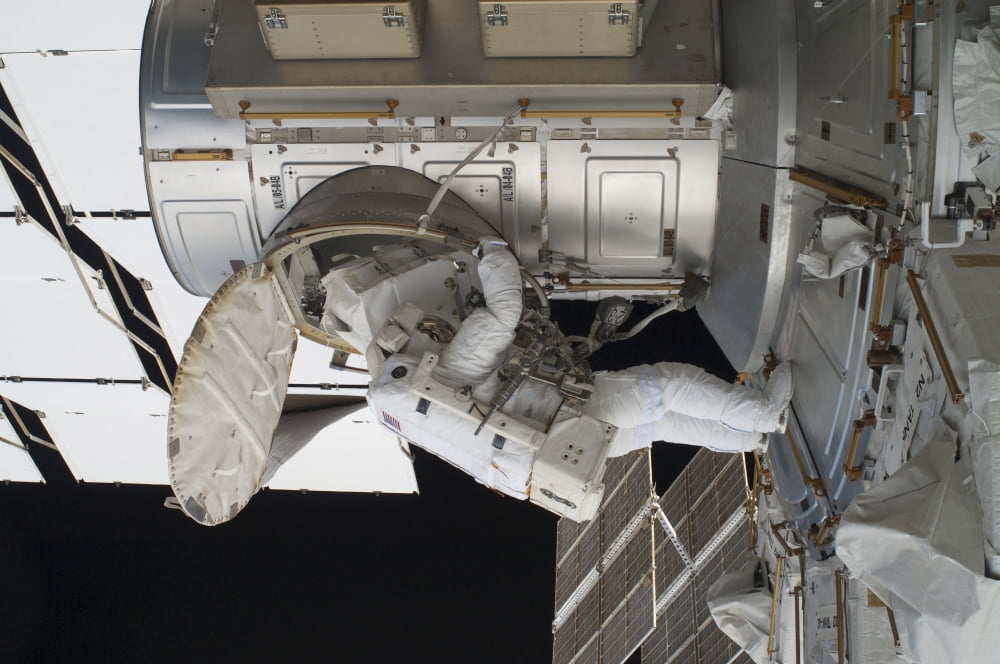 Astronaut egresses the Quest airlock on the International Space Station Canvas Art - Stocktrek Images (34 x 23)