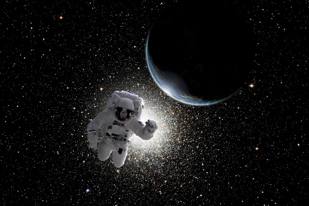 Astronaut floating in deep space with an Earth-like planet in background Canvas Art - Marc WardStocktrek Images (17 x 12)