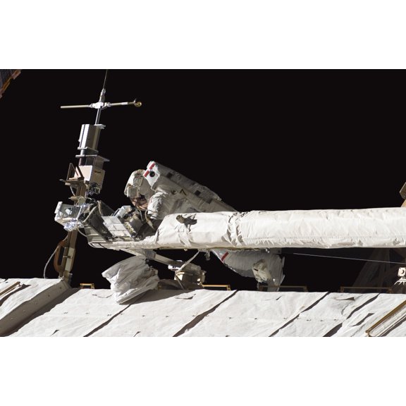 Astronaut helps to tie down the Orbiter Boom Sensor System on the International Space Stations S1 truss Canvas Art - Stocktrek Images (34 x 23)