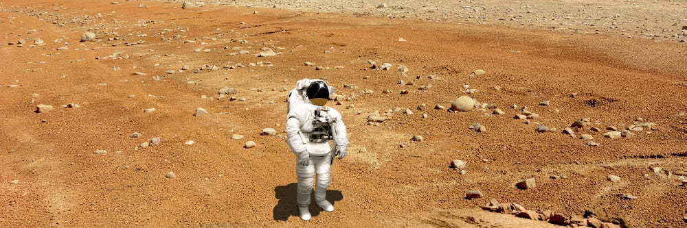 Astronaut looking up at an alien sun that illuminates the barren world he stands on Canvas Art - Marc WardStocktrek Images (24 x 8)