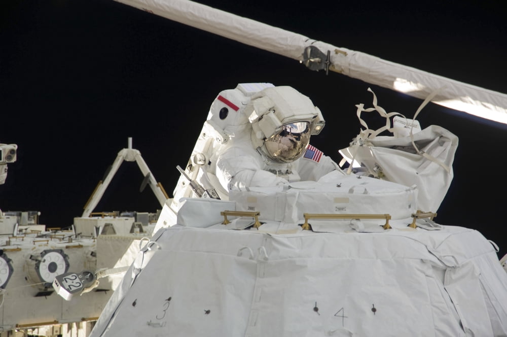 Astronaut participates in a session of extravehicular activity Canvas Art - Stocktrek Images (34 x 23)