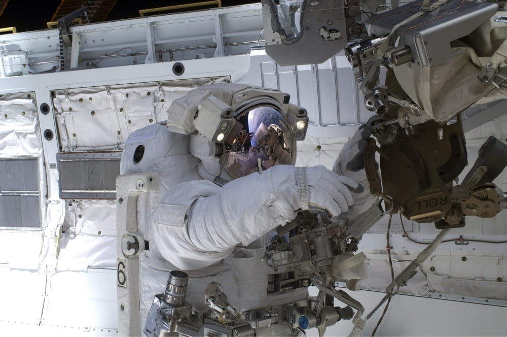 Astronaut participates in a session of extravehicular activity Canvas Art - Stocktrek Images (34 x 23)