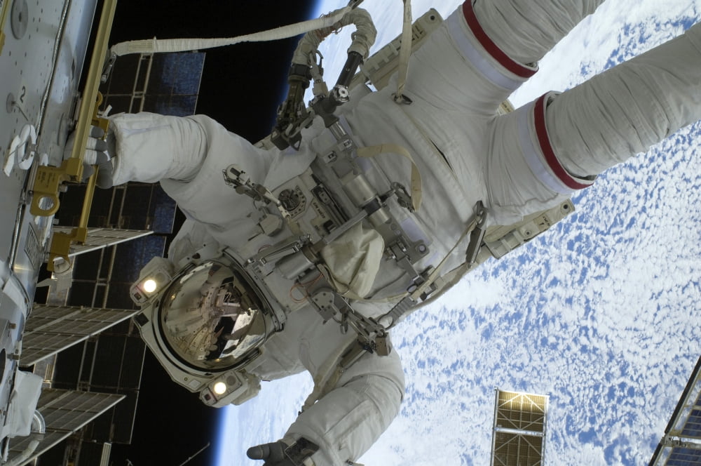 Astronaut participates in a session of extravehicular activity Canvas Art - Stocktrek Images (34 x 23)