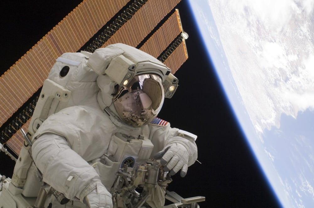 Astronaut participates in a session of extravehicular activity Canvas Art - Stocktrek Images (34 x 23)