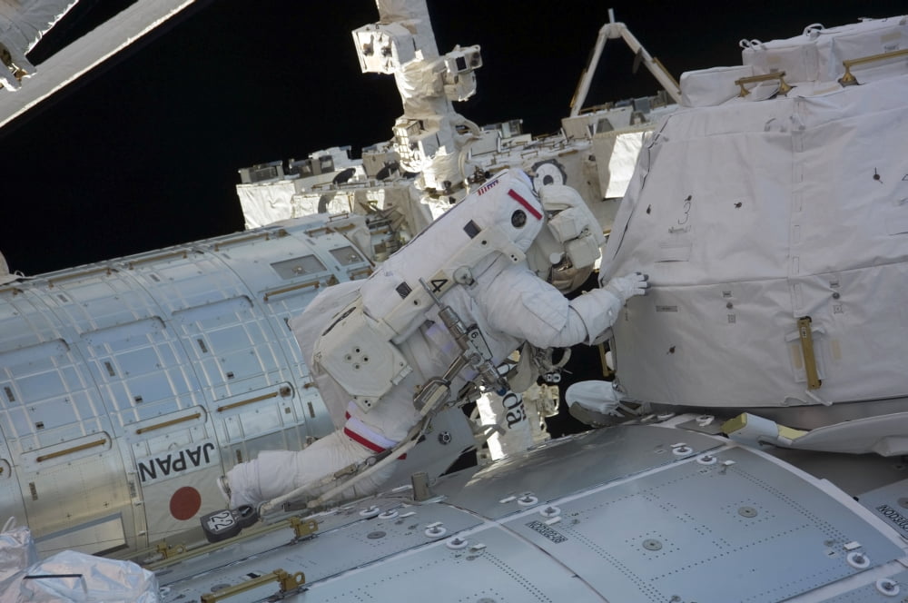 Astronaut participates in a session of extravehicular activity Canvas Art - Stocktrek Images (34 x 23)
