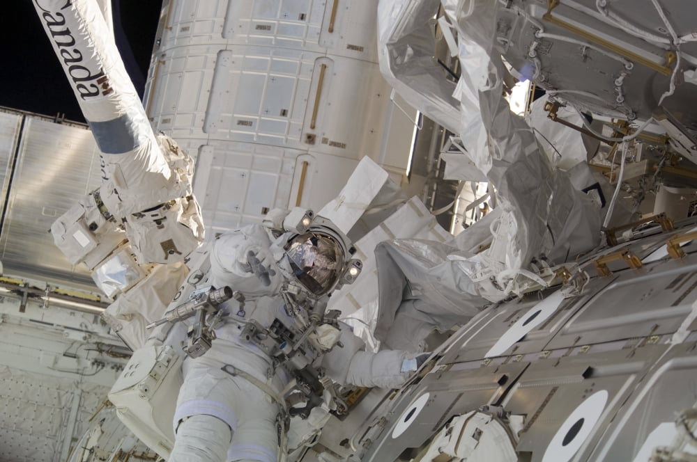 Astronaut participates in a session of extravehicular activity Canvas Art - Stocktrek Images (34 x 23)