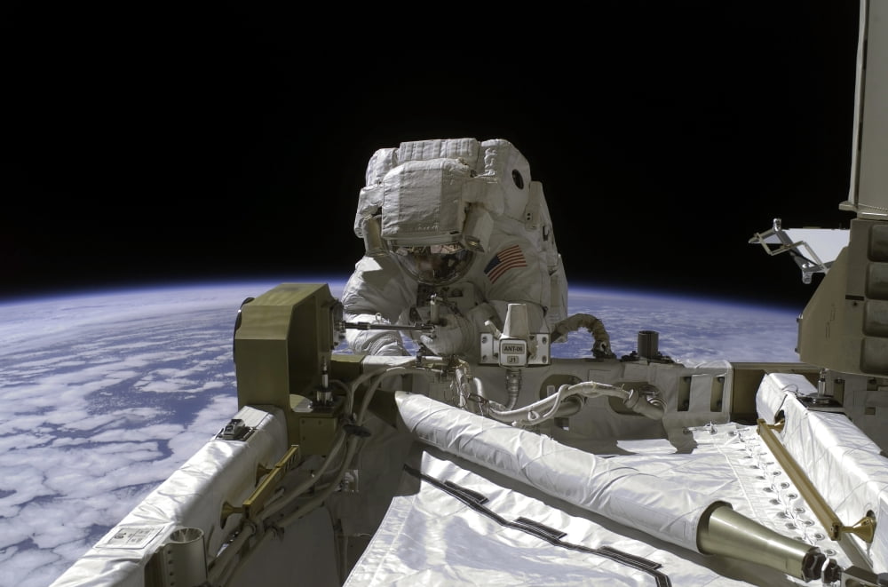 Astronaut participates in a spacewalk Canvas Art - Stocktrek Images (34 x 23)