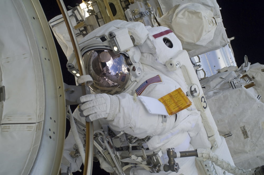 Astronaut participates in a spacewalk outside the International Space Station Canvas Art - Stocktrek Images (35 x 23)