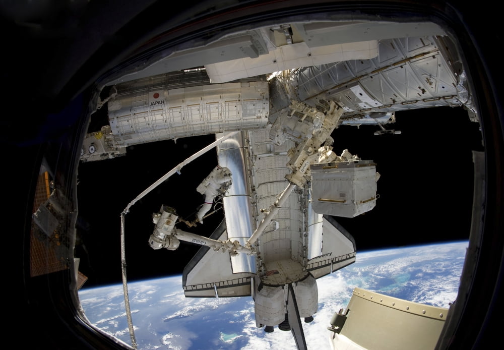 Astronaut participates in a spacewalk while anchored to a foot restraint Canvas Art - Stocktrek Images (34 x 24)