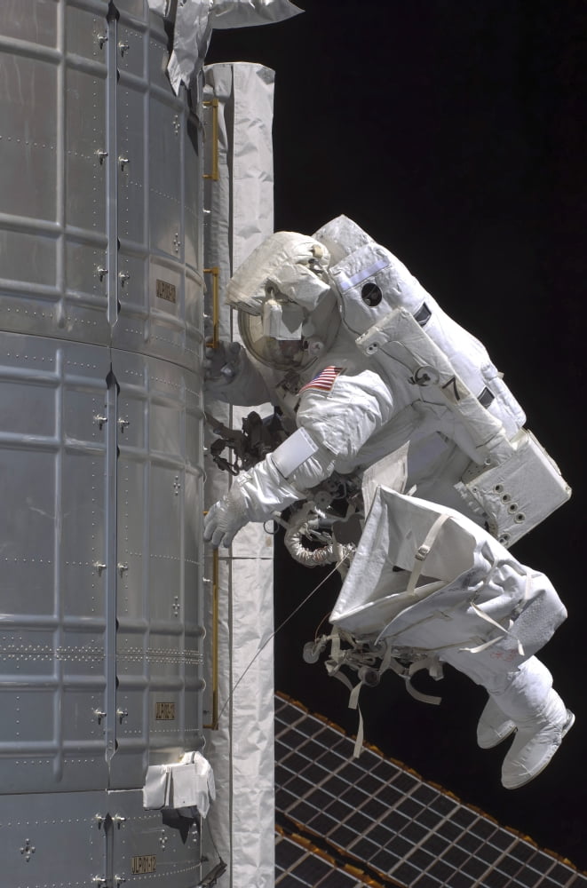 Astronaut participates in extravehicular activity Canvas Art - Stocktrek Images (23 x 35)
