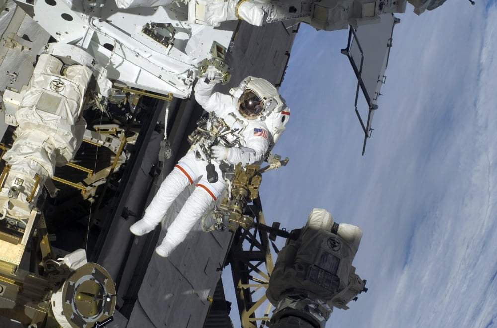 Astronaut participates in extravehicular activity Canvas Art - Stocktrek Images (34 x 23)