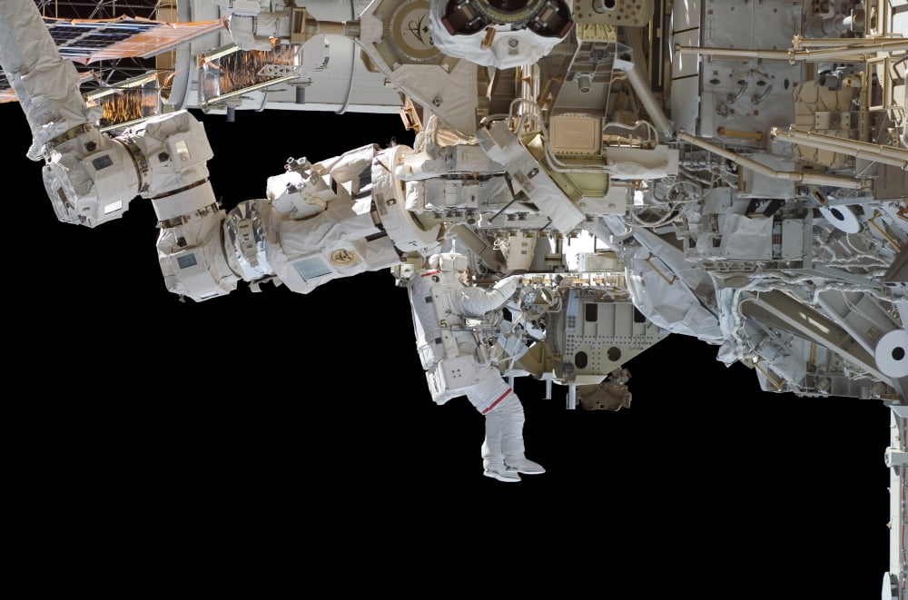 Astronaut participates in extravehicular activity Canvas Art - Stocktrek Images (34 x 23)