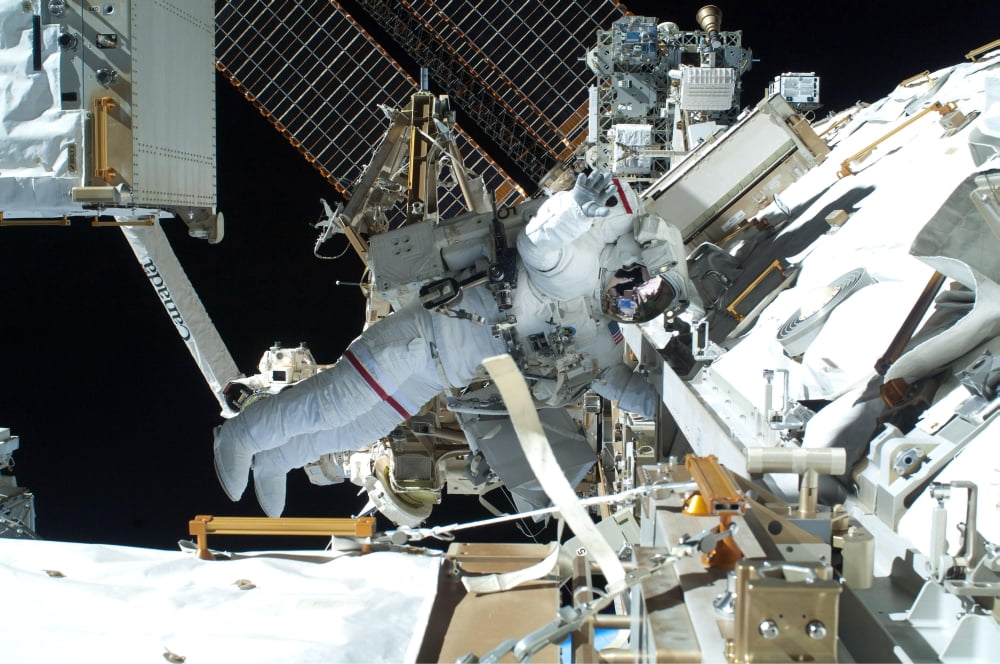 Astronaut participates in extravehicular activity Canvas Art - Stocktrek Images (34 x 23)
