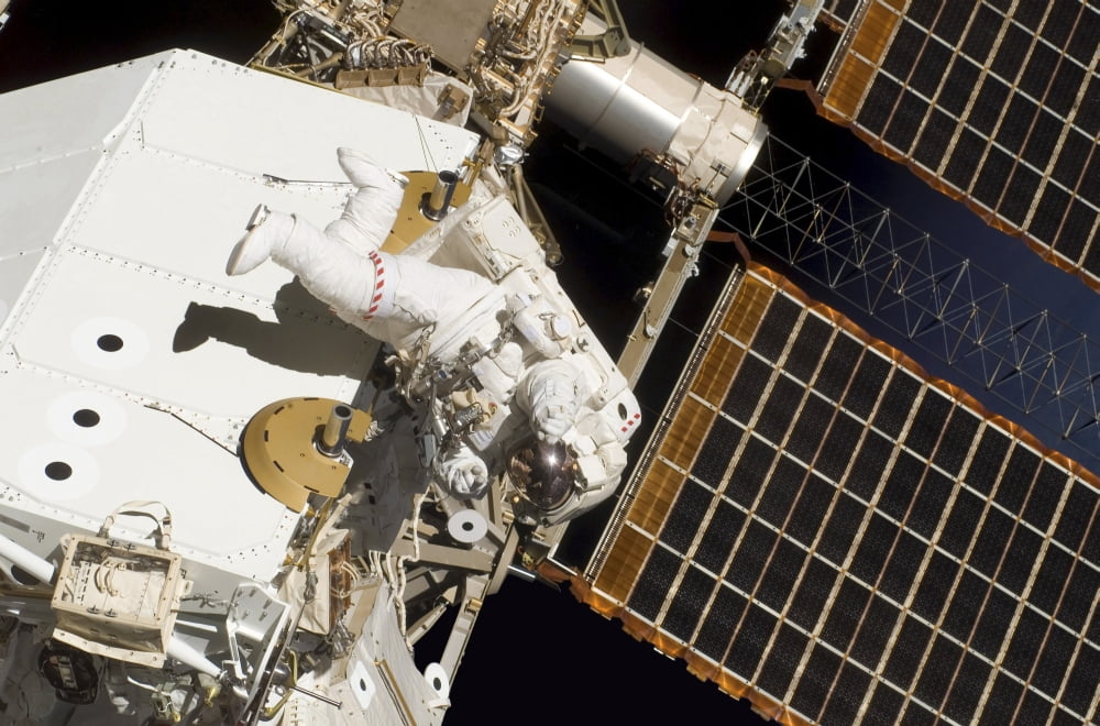 Astronaut participates in extravehicular activity Canvas Art - Stocktrek Images (34 x 23)