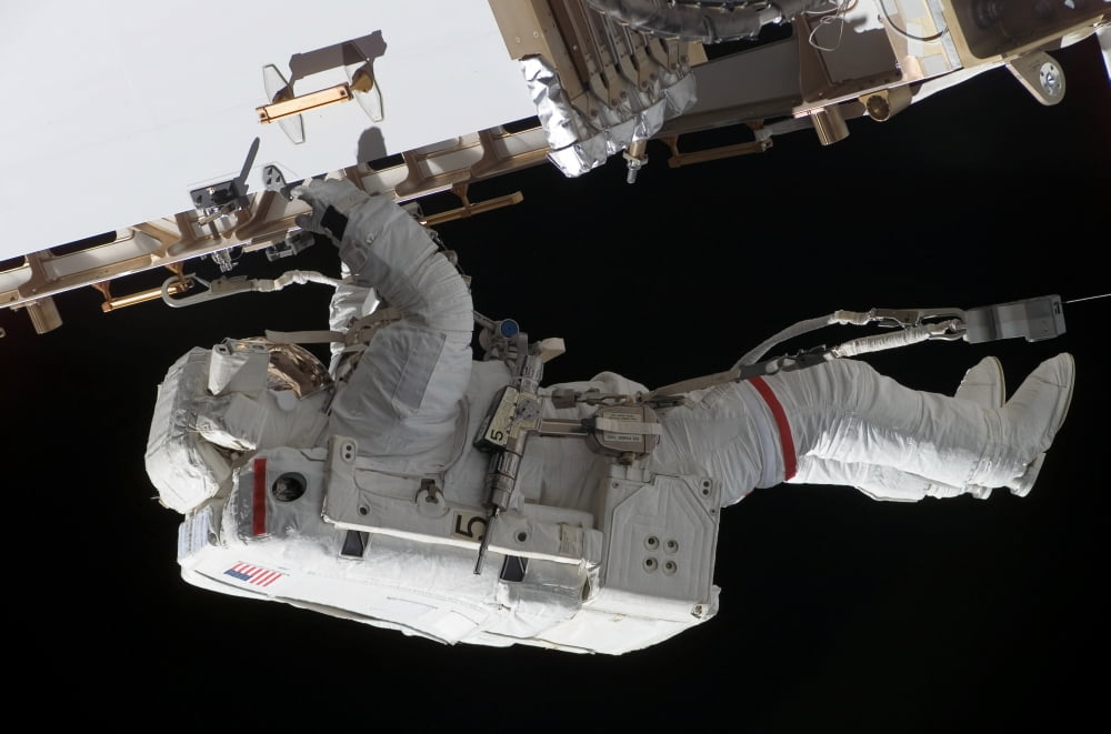Astronaut participates in extravehicular activity Canvas Art - Stocktrek Images (34 x 23)