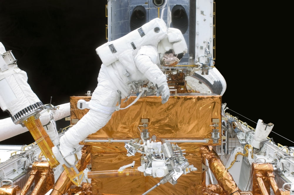 Astronaut participates in extravehicular activity Canvas Art - Stocktrek Images (34 x 23)
