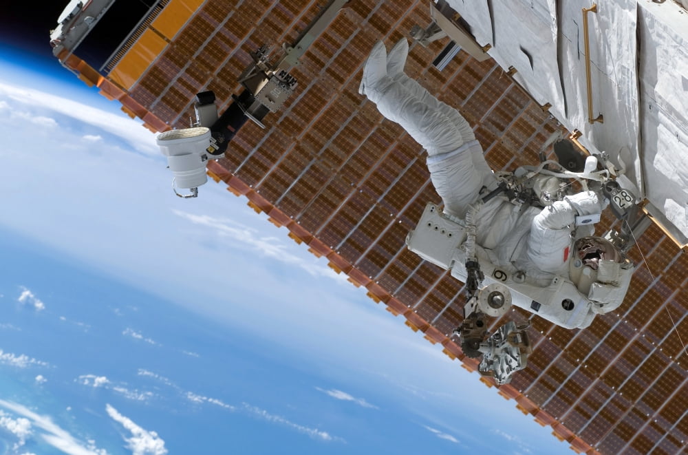 Astronaut participates in extravehicular activity Canvas Art - Stocktrek Images (34 x 23)