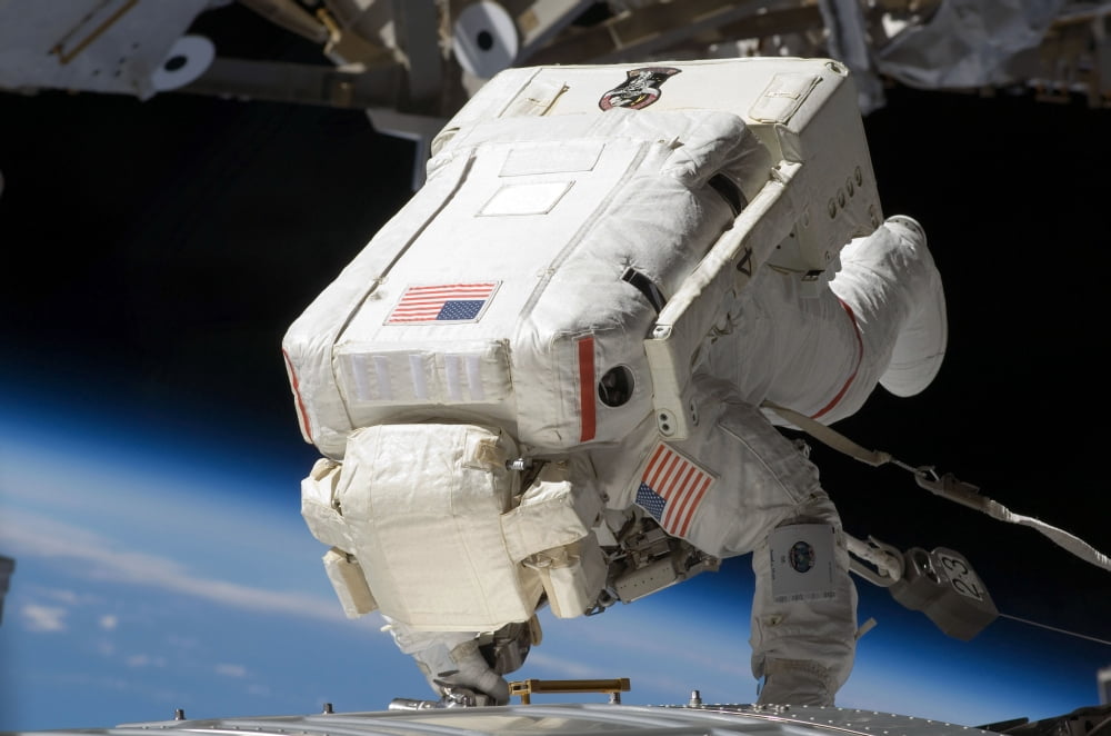 Astronaut participates in extravehicular activity Canvas Art - Stocktrek Images (34 x 23)