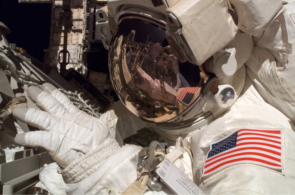Astronaut participates in extravehicular activity Canvas Art - Stocktrek Images (34 x 23)