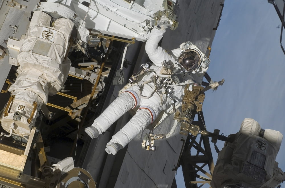 Astronaut participates in extravehicular activity Canvas Art - Stocktrek Images (34 x 23)