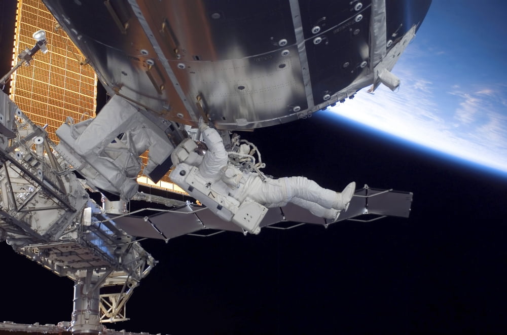 Astronaut participates in extravehicular activity Canvas Art - Stocktrek Images (34 x 23)
